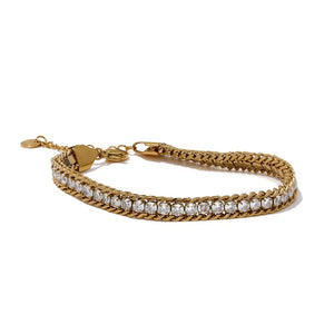 Gold bracelet with heart clasp on a white background