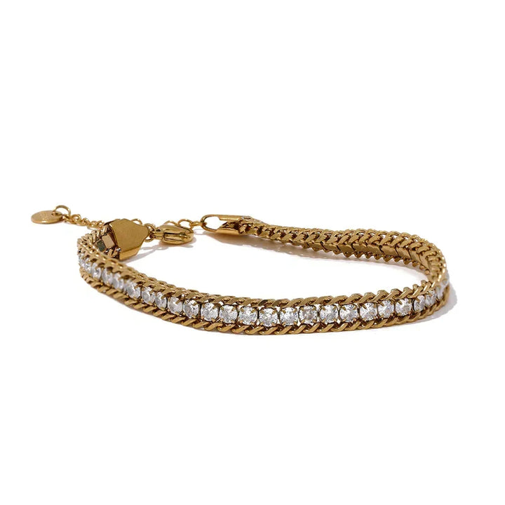 Gold bracelet with heart clasp on a white background