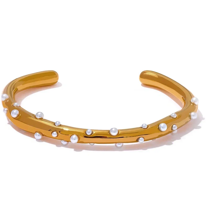 Gold bracelet with pearls on a white background