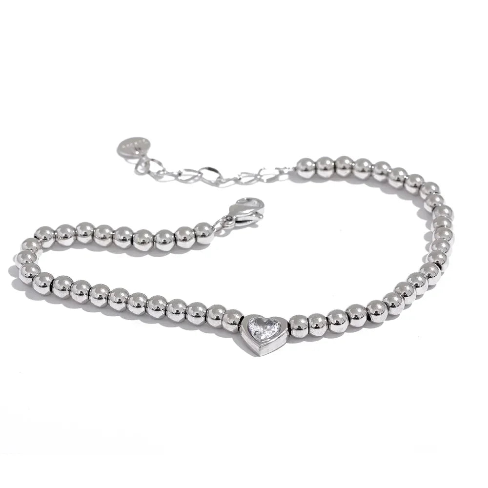 925 silver beaded bracelet with heart-shaped crystal centerpiece on white background
