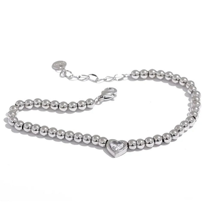 925 silver beaded bracelet with heart-shaped crystal centerpiece on white background