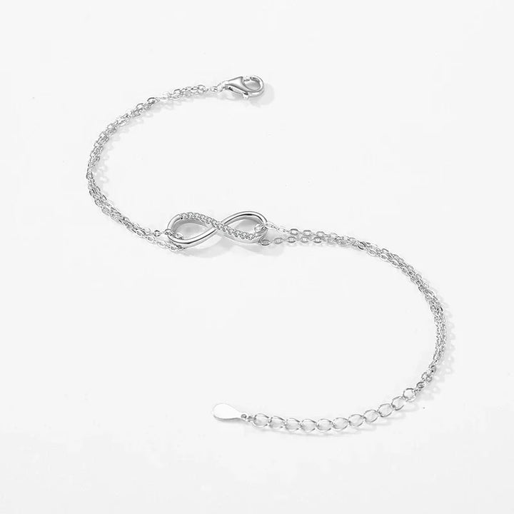 925 silver infinity symbol bracelet with adjustable chain on white background