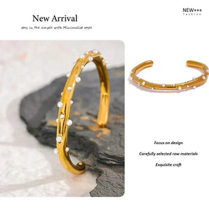 Gold bracelet with white stones on a textured surface, labeled 'New Arrival' by NEW++ Fashion.