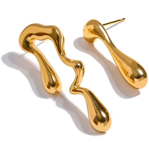 Gold abstract earrings on a white background