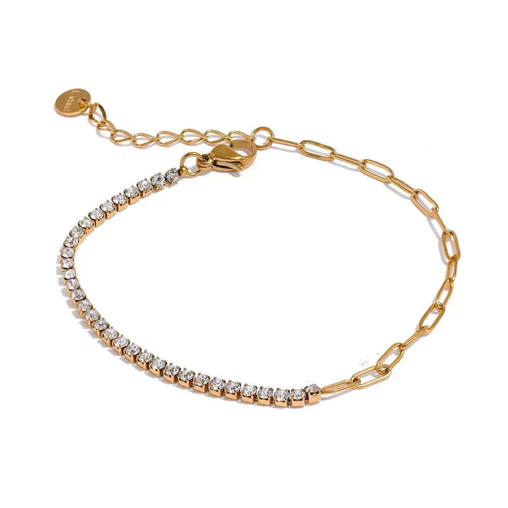Gold-plated bracelet with paperclip chain and row of clear crystals on white background