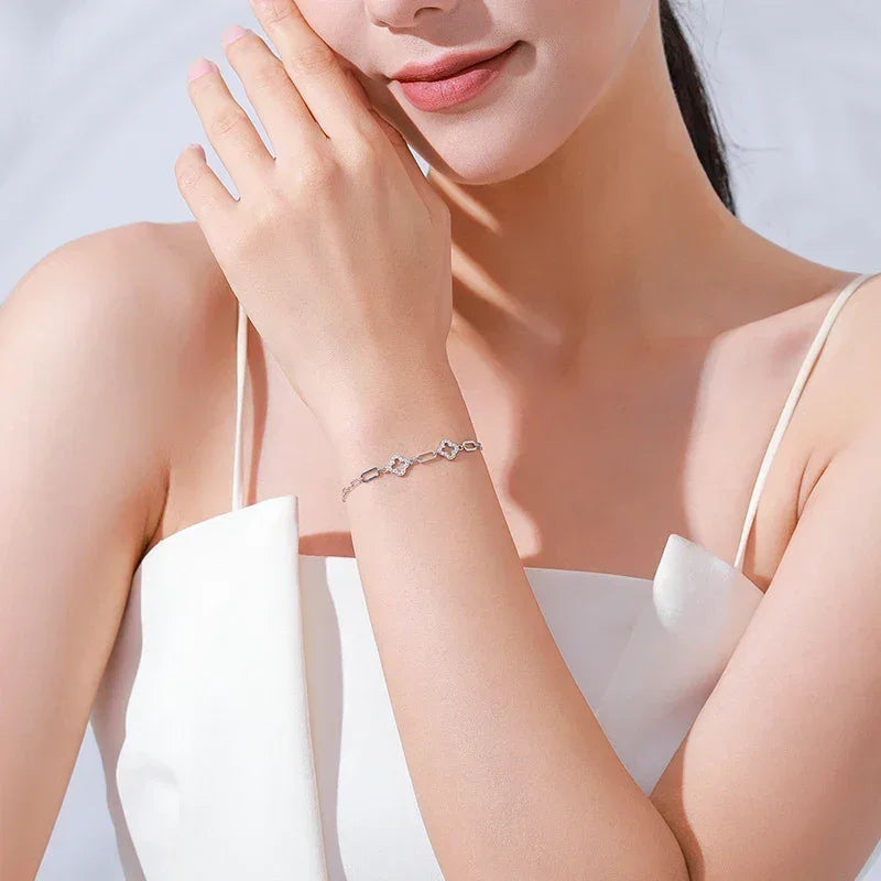 Woman wearing elegant silver bracelet with geometric links, minimalist jewelry style