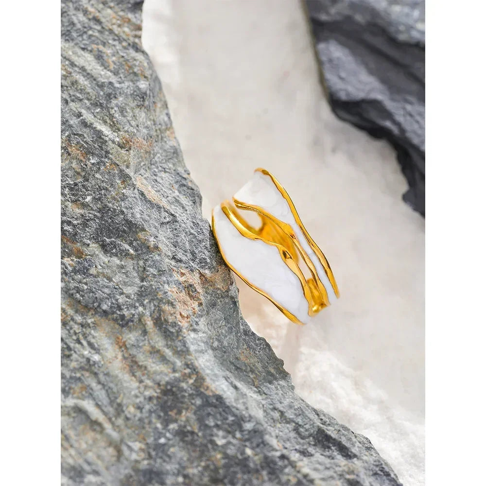 18K gold-plated silver ring with abstract design on stone background