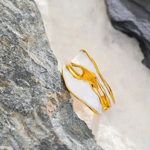 18K gold-plated silver ring with abstract design on stone background