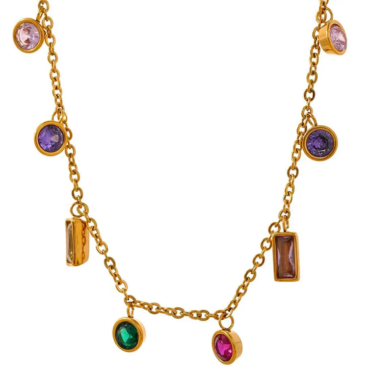 Gold necklace with colorful gemstones on a white background
