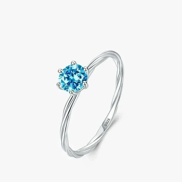 Silver ring with a blue gemstone on a white background