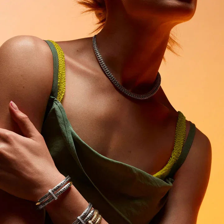 Woman wearing a green bikini with yellow straps against an orange background