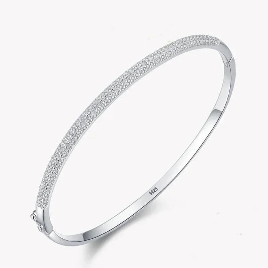 Sterling silver 925 bangle bracelet with pavé cubic zirconia on white background