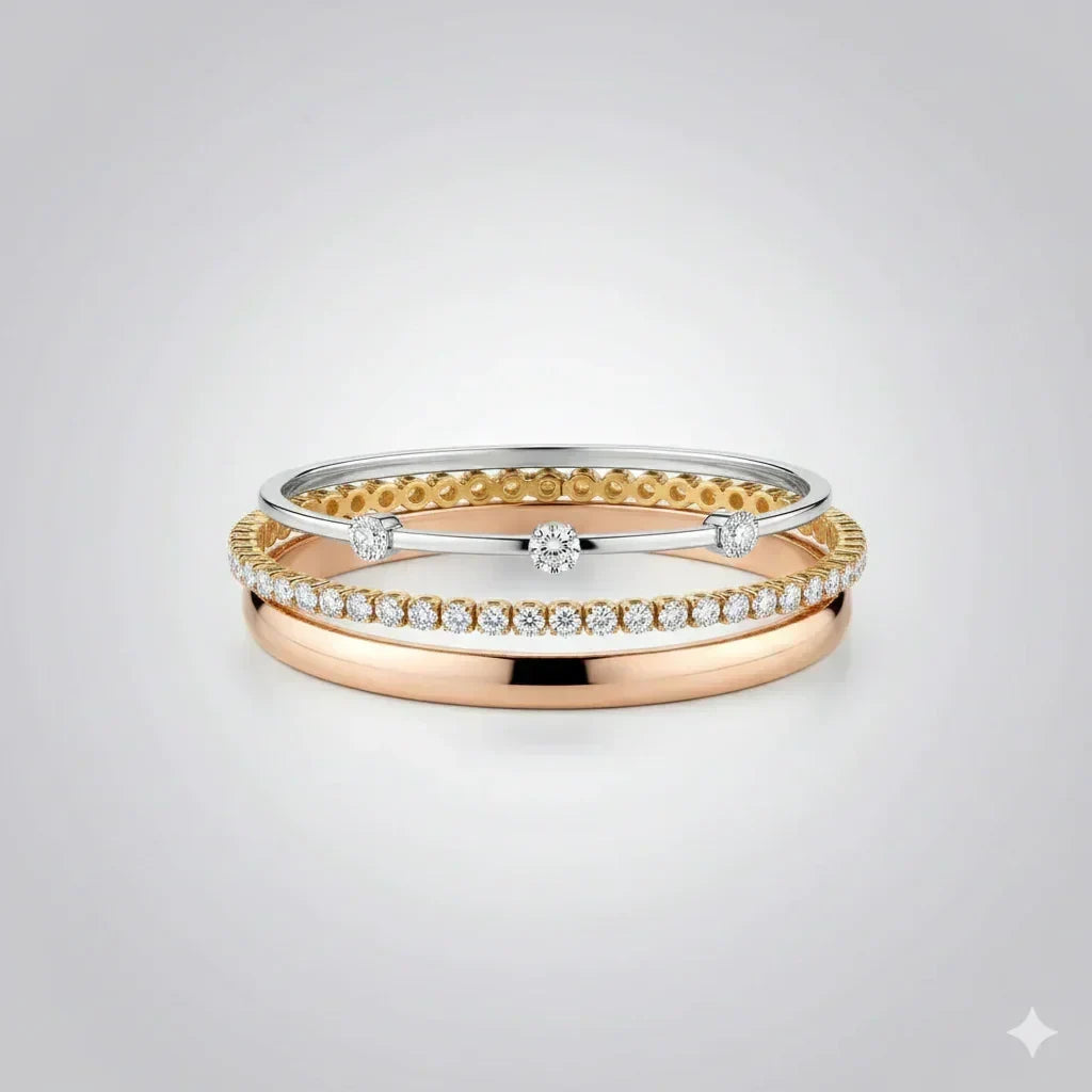 Three gold rings with diamond accents on a light gray background
